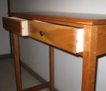 dovetailed drawers with ebonized cherry knobs